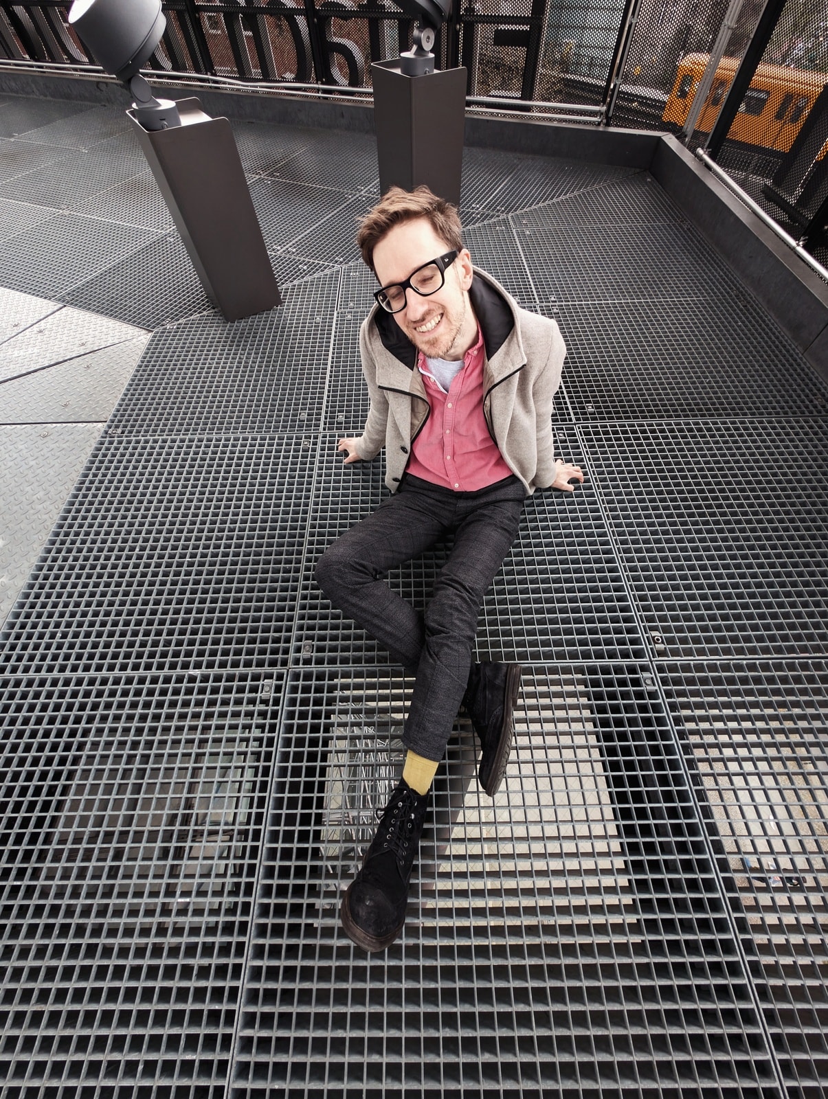 Me, sitting on a metal grid floor, like those used in emergency staircases. I’m smiling with my eyes closed, my face turned toward the sky.